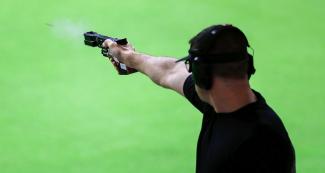 Keith Sanderson from United States aims at the target during the 25 m rapid fire pistol event of the Lima 2019 Pan American Games at Las Palmas Air Base.