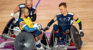 Brazilian Alexandre Giuriato fights for the ball against Colombians John Orozco and Carlos Neme in Lima 2019 wheelchair rugby match at the Villa El Salvador Sports Center