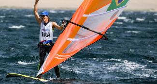 Patrícia Freitas of Brazil celebrates winning the gold medal in the Lima 2019 women’s windsurf competition at Paracas Bay.