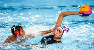 Canadian Krystina Algobo and cuban Mayelin Bernal facing off in Water Polo match at the Lima 2019 Games in Villa María del Triunfo