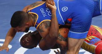 Dichter Toro from Colombia faces off Andres Montaño from Ecuador in Greco-Roman wrestling at the Callao Regional Sports Village