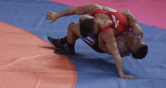 Ismael Borrero from Cuba and Shalom Villegas from Venezuela competing in Greco-Roman wrestling at the Callao Regional Sports Village