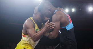 Angelo Marques from Brazil faces off Yosvanys Peña from Cuba in Greco-Roman wrestling at the Callao Regional Sports Village