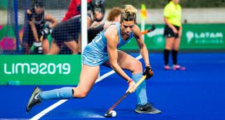 Argentinian athlete controlling the ball during Lima 2019 hockey match for the gold against Canada at the National Sports Village (VIDENA)