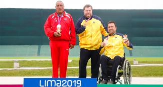 Mariano Heredia from Cuba (silver), Geraldo Rosenthal from Brazil (gold) and Adrian Sergio from Brazil (bronze) posing with their medals in 50m pistol in Lima 2019 at Las Palmas
