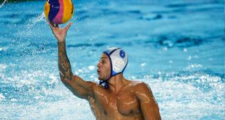 Cuban Remmy de Armas Rios dominating the ball in Water Polo competition against USA at the Lima 2019 Games in Villa María del Triunfo