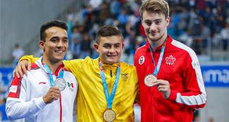 Juan Hernandez from Mexico (silver), Daniel Restrepo from Colombia (gold) and Philippe Gagné from Canada (bronze) pose with their diving medals in the Lima 2019 men’s 3 m springboard competition at the National Sports Village – VIDENA.