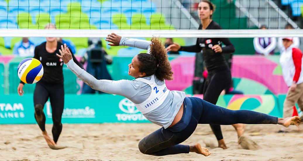 Lolette Rodríguez defends the ball against Canada’s attack - Beach volleyball