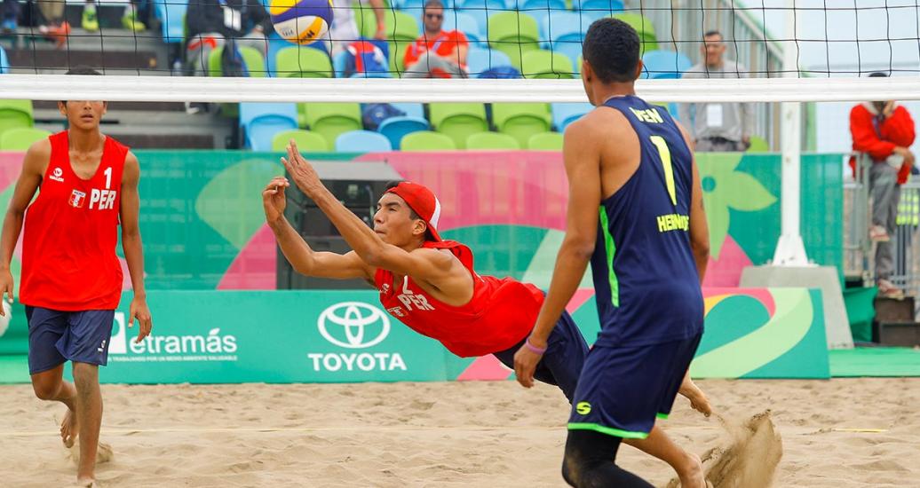 Gabriel Vásquez of Peru saves a beach volleyball play 