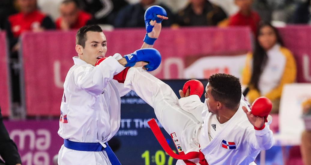Anderson Soriano from the Dominican Republic competes against his US opponent, Thomas Scott, in karate at the Lima 2019 Games, at the Villa El Salvador Sports Center.