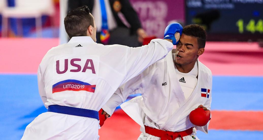 USA’s Thomas Scott throws a punch at Anderson Soriano from the Dominican Republic, during the Lima 2019 Games karate competition at the Villa El Salvador Sports Center.