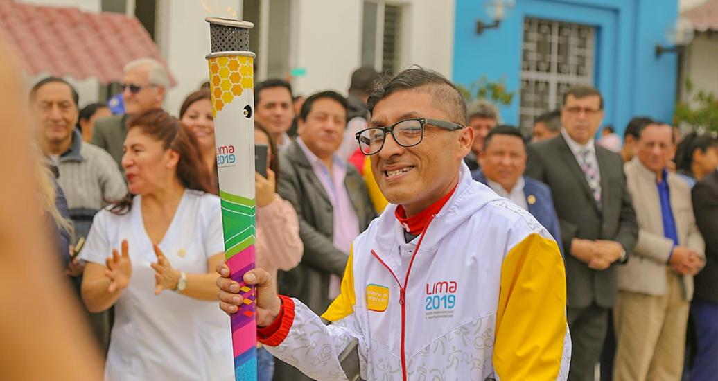 A torchbearer moves with the torch in his hand on the third day of the Lima 2019 Parapan American Torch Relay