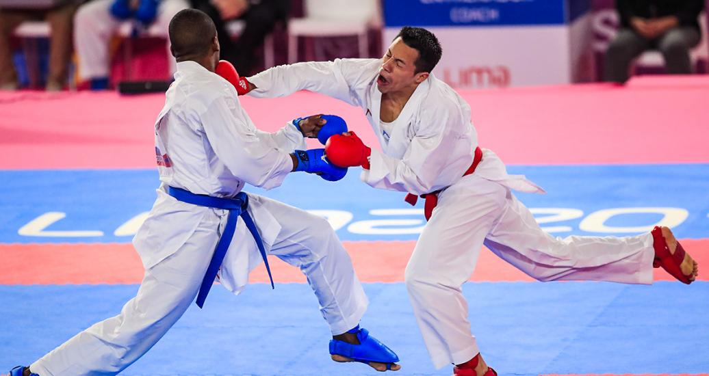 Guatemalan Allan Maldonado retaliates against Brazilian Hernani Verissimo in karate kumite during the Lima 2019 Games, at the Villa El Salvador Sports Center.