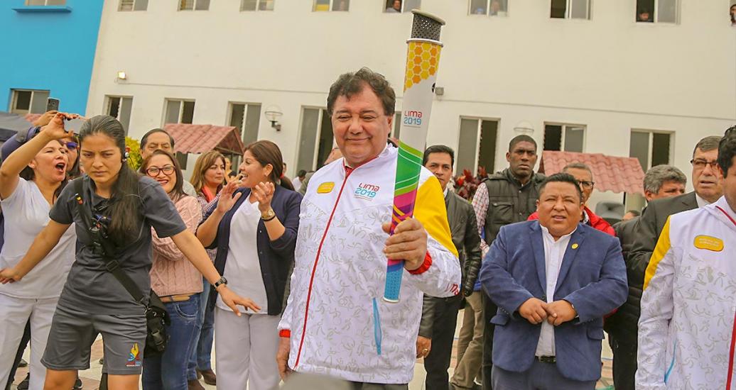 A torchbearer moves in front of the crowd on the third day of the Lima 2019 Parapan American Torch Relay