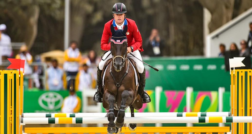 A rider and his horse jumping an obstacle in Lima 2019 equestrian jumping individual event at the Army Equestrian School