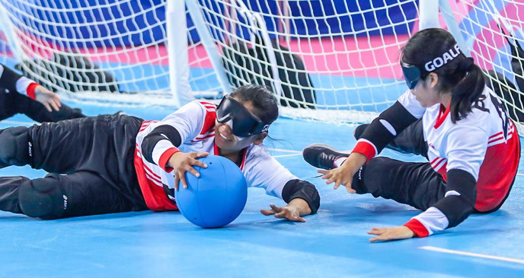 Erika Inuma and Milagros Cotrina, from Peru, compete against Canada during the goalball match at the Lima 2019 Parapan American Games in the Callao Regional Sports Village