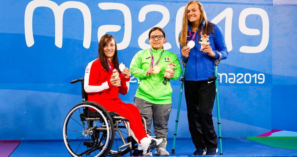 Krystal Shaw from Canada (silver), Naomi Somellera from Mexico (gold) and Abigail Gase from the US (bronze) proudly posing with their medals in women’s 50 m freestyle S7 Para swimming competition during medal ceremony at the Lima 2019 Parapan American Games