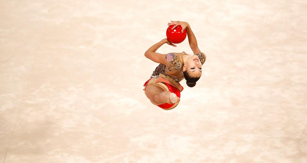 Colombian Oriana Viñas showcasing a graceful jump in her individual rhythmic gymnastics routine at Villa El Salvador Sports Center at the Lima 2019 Games