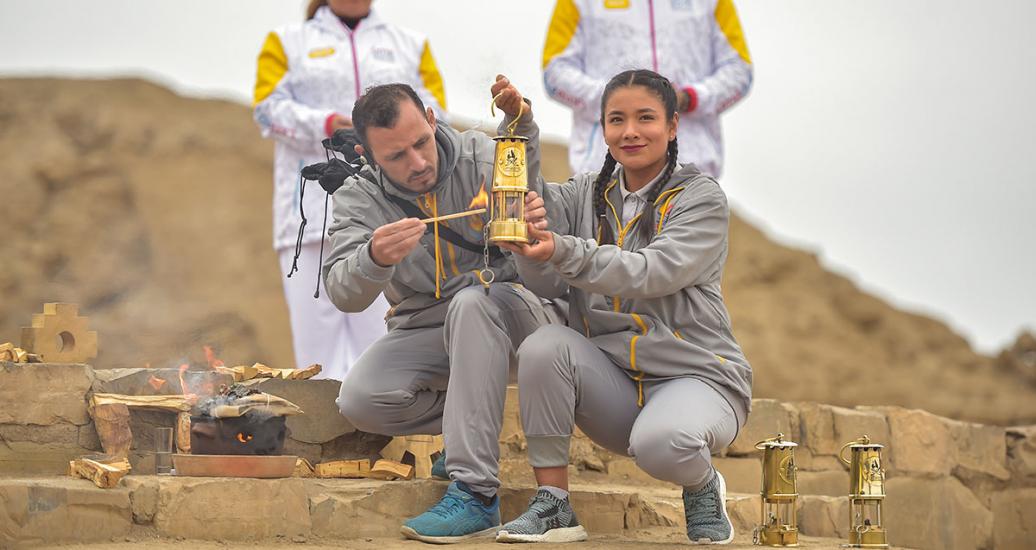 Peruvian athletes light the Lima 2019 Parapan American Torch in Pachacamac.