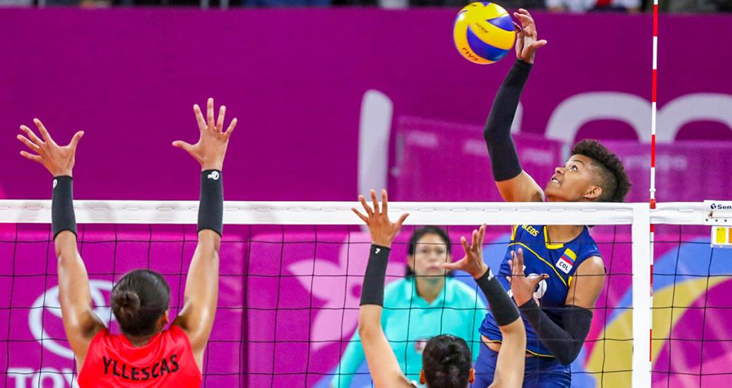Volleyball player María Margarita Martínez of Colombia spikes the ball. She scored 11 points against Peru at the Lima 2019 Games.