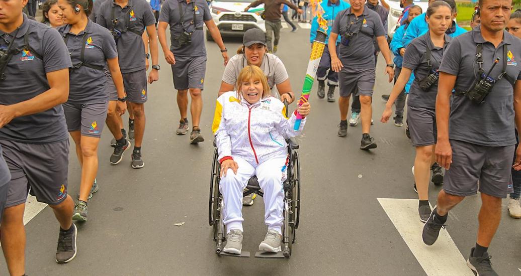 The Lima 2019 Ambassador Gina Parker carries the torch and broadly smiles on the third day of the Lima 2019 Parapan American Torch Relay