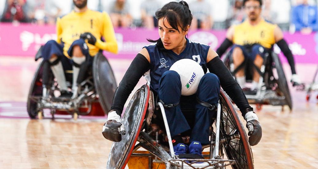 Colombian Paola Martinez controls the ball against Brazil in wheelchair rugby at the Villa El Salvador Sports Center during the Lima 2019 Parapan American Games