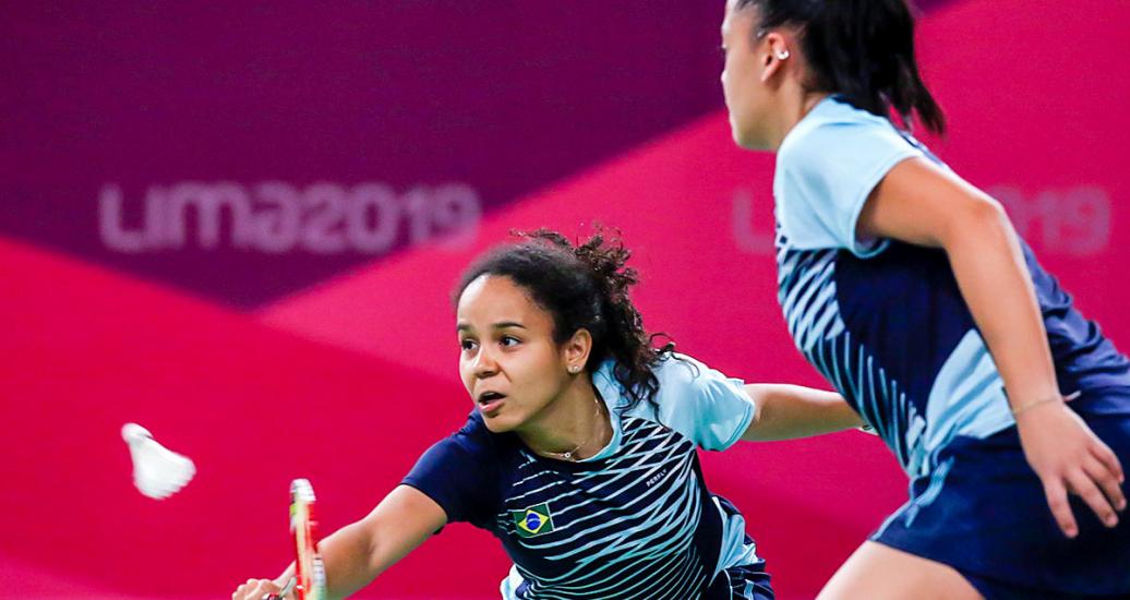 Santos Tamires and Fabiana Silva from Brazil respond to a Canadian attack in a badminton doubles event held at the National Sports Village – VIDENA at the Lima 2019 Pan American Games