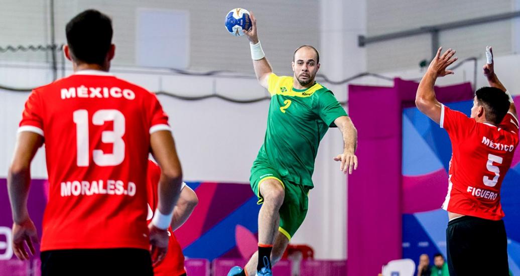 Henrique Teixeira from Brazil plays handball against Sayyed Morales and David Figueroa from Mexico.