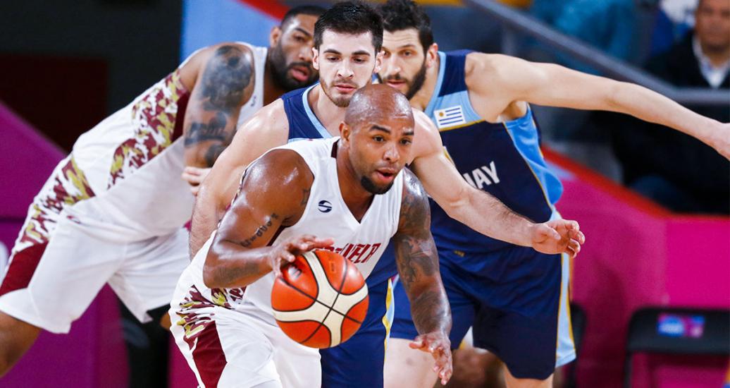 Gregory Vargas from Venezuela controls the ball chased by Venezuelan basketball players at the Eduardo Dibós Coliseum during the Lima 2019 Games