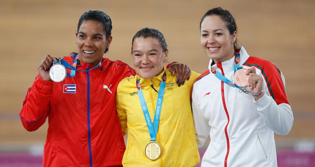 Lisandra Guerra from Cuba, Martha Bayona from Colombia, and Yuli Verdugo from Mexico showing gold, silver and bronze medals after their victory at Lima 2019 cycling competition