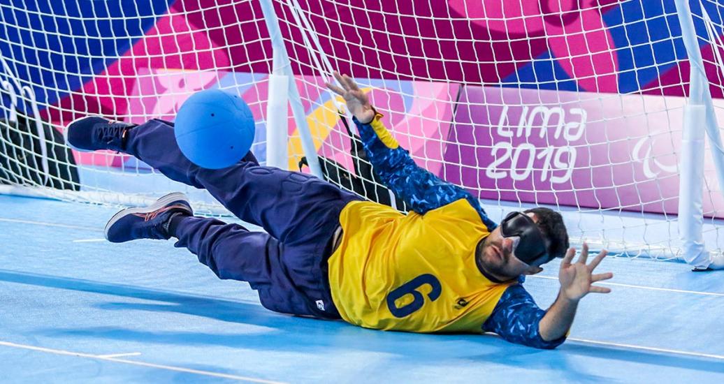 Brazilian Romario Marques dives for the ball in the goalball match against Mexico at the Callao Regional Sports Village