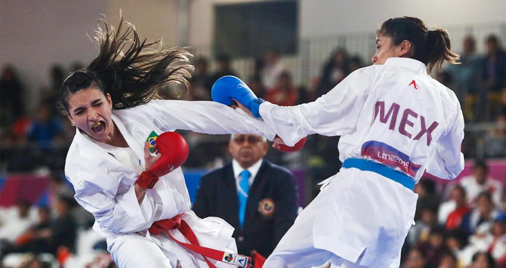 Mexican Alicia Hernández and Brazilian Jessica De Paula face off during the Lima 2019 karate competition at the Villa El Salvador Sports Center.
