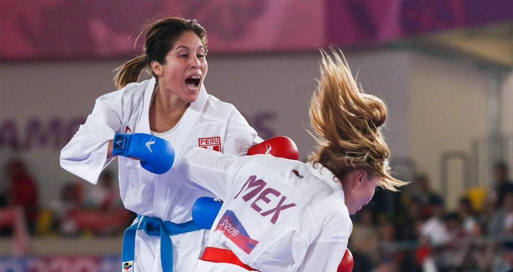 Peruvian Alexandra Grande and Mexico Xhunashi Caballero perform moves in kumite (karate) at the Villa El Salvador Sports Center at Lima 2019.