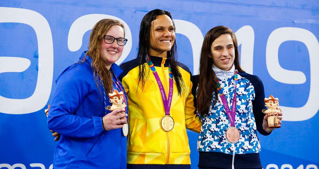 USA’s Aspen Shelton, alongside Brazilian María Gomes and Argentinian Analuz Pellitero win the Para swimming breaststroke competition of the Lima 2019 Parapan American games, held in the National Sports Village – VIDENA