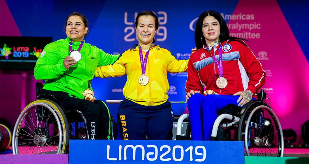 Miriam Aguilar de México (plata), Mariana D’Andrea de Brasil (oro) y Pamela Muñoz de Chile (bronce) posan orgullosas con sus medallas de Para powerlifting combinación mujeres 61 kg & 67 kg AH en Lima 2019 en la Villa Deportiva Nacional – VIDENA