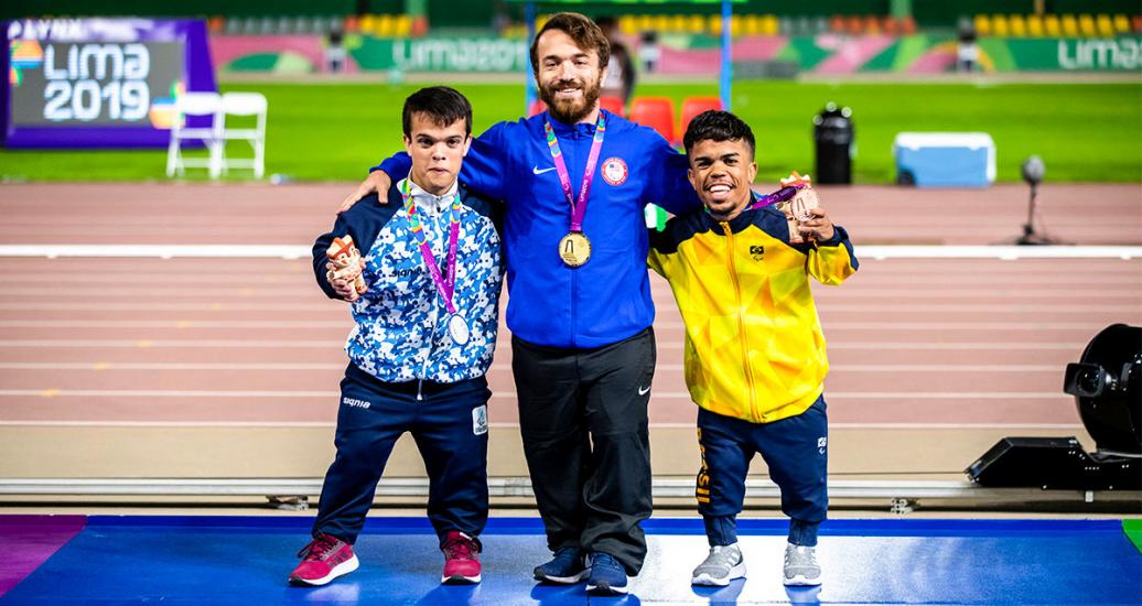 Hagan Landry from the USA (gold), Andres Pinillos from Argentina (silver) and Jair Henrique from Brazil (bronze) pose on the podium with their shot put F40/41 medals at the National Sports Village - VIDENA