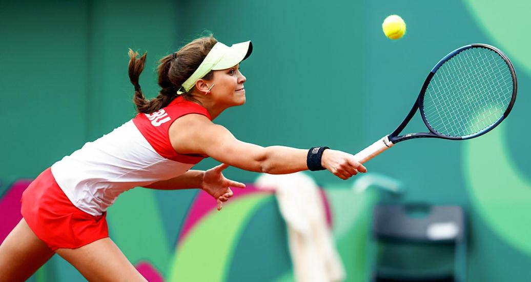 Peruvian tennis player, Dominique Schaefer, stretching to reach the ball at the Lawn Tennis Club at Lima 2019