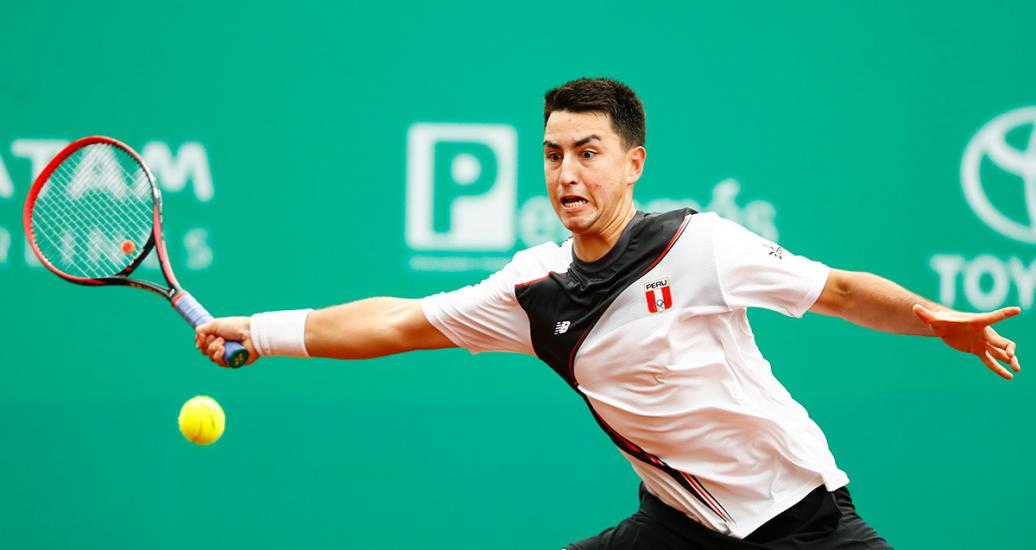Peruvian tennis player tries to stop Chilean Harry Nicolás at the Lawn Tennis Club at Lima 2019 
